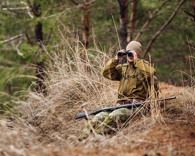 Female hunter waiting on slope